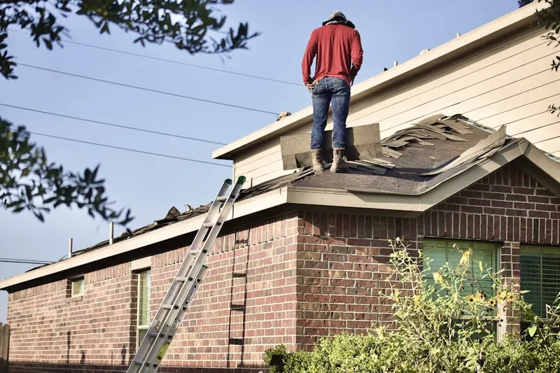 Professional roofer working on a residential roof in Hayford